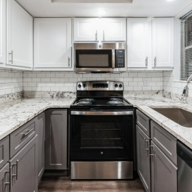 Modern kitchens at Harbourtowne at Countrywoods with white cabinetry and stainless steel appliances