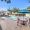 Pool and Sundeck with Tables and Chairs with Umbrellas
