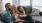 Lifestyle photo of a family of three sitting on the couch 